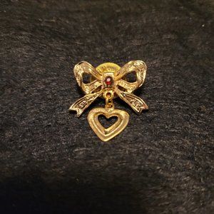Bow lapel pin with red rhinestone and dangling heart